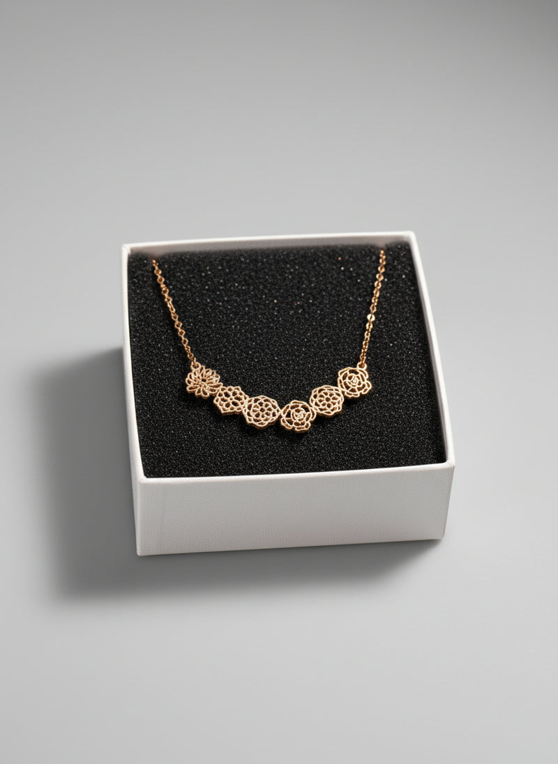 Gold necklace in a white box on a black background