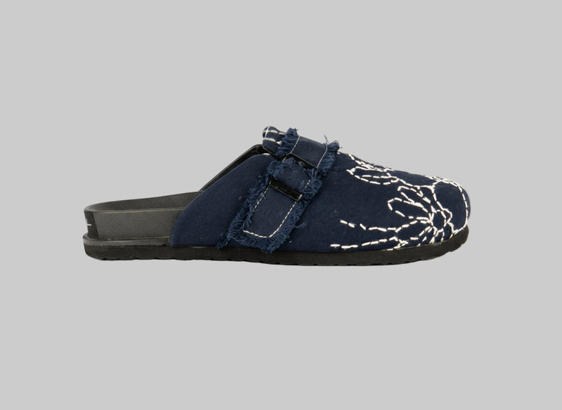 Navy blue sandal with white floral embroidery on a white background