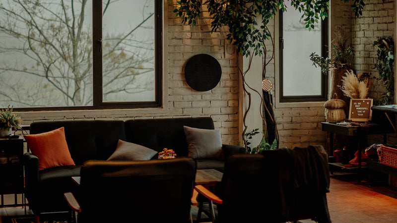 Cozy indoor setting with dark furniture and warm lighting